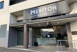 A doorway with the words Meriton Suites written at the top.