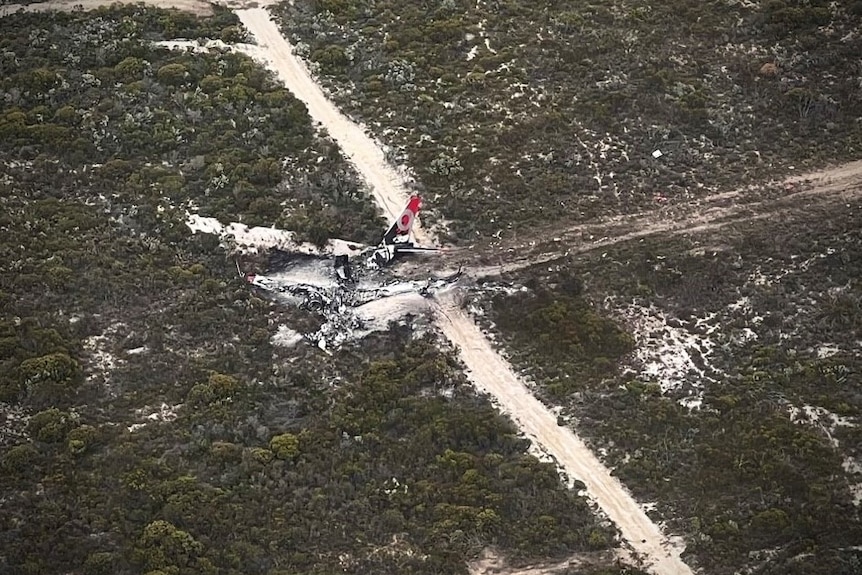 The charred remains of an aircraft in scrub land