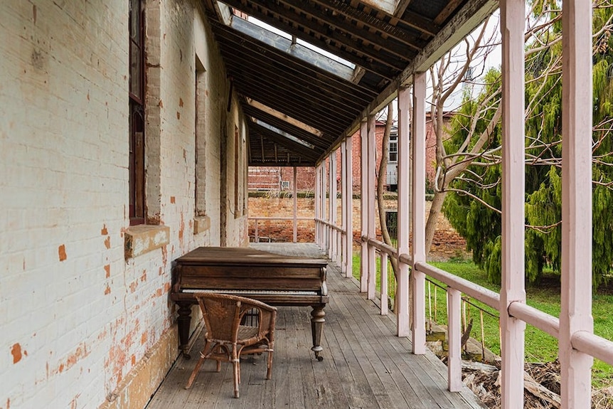 A verandah and railing at an old home.