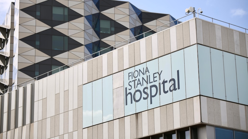 A close up of a sign on the side of the building which says "Fiona Stanley Hospital".