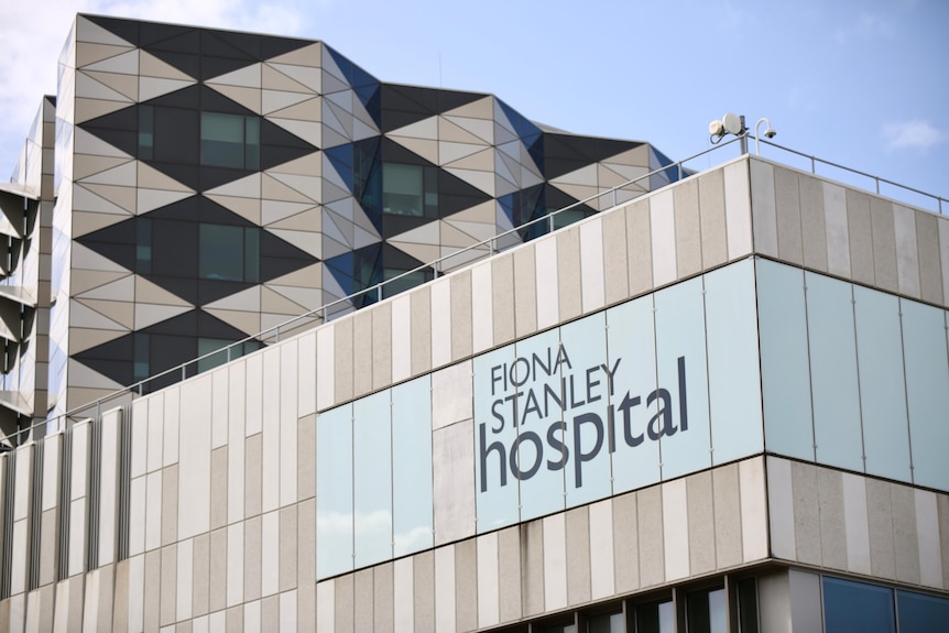 A close up of a sign on the side of the building which says "Fiona Stanley Hospital".