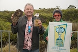 Man holds large oyster alongside his trophy