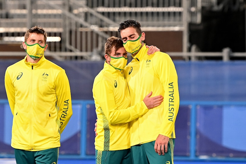 Kookaburras players console each other.