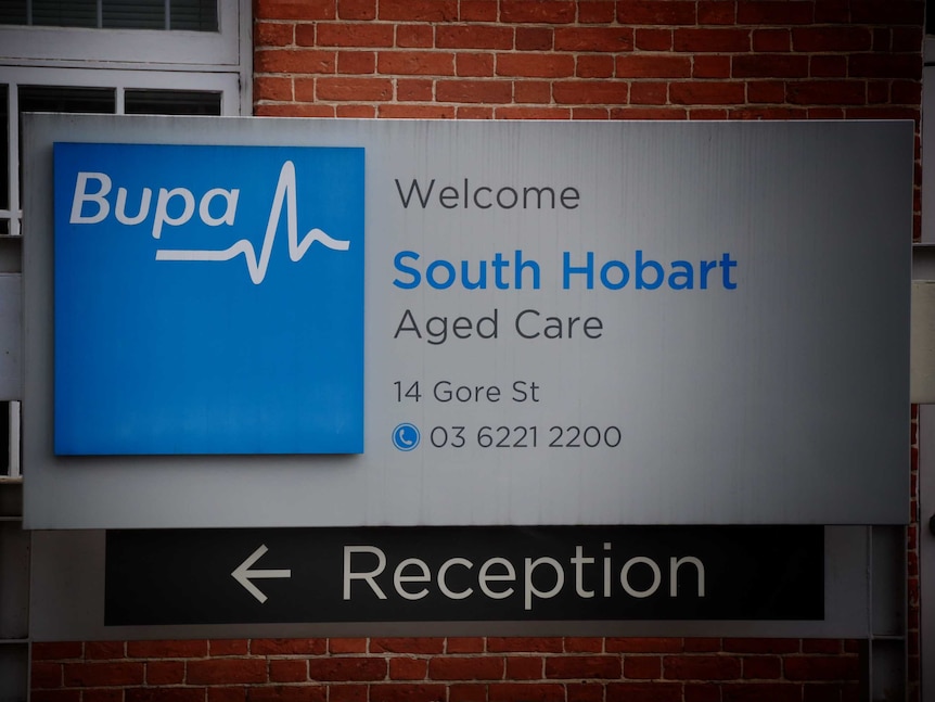 A sign at the front of a building with a blue Bupa logo saying Welcome south hobart aged care.