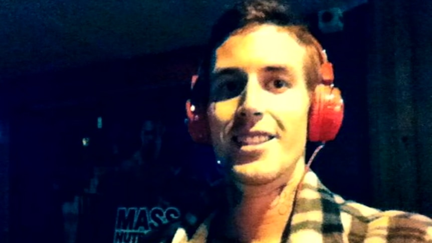 Marcus Martin smiling and wearing headphones