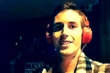 Marcus Martin smiling and wearing headphones