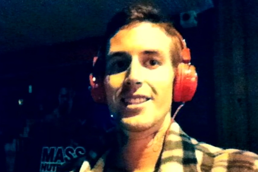 Marcus Martin smiling and wearing headphones