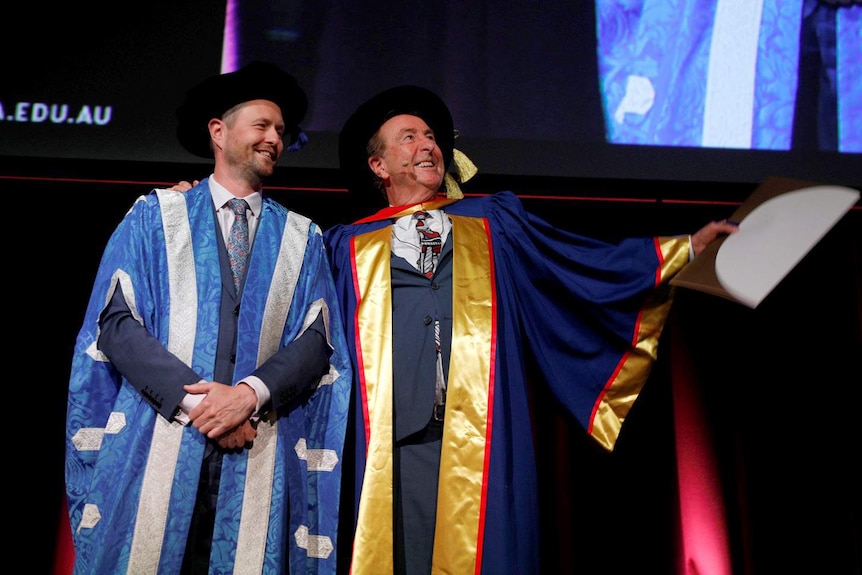 UniSA Professor David Lloyd on stage with Monty Python member Eric Idle.