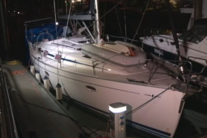 Luxury yacht Solay moored at marina on Queensland's Gold Coast at night.