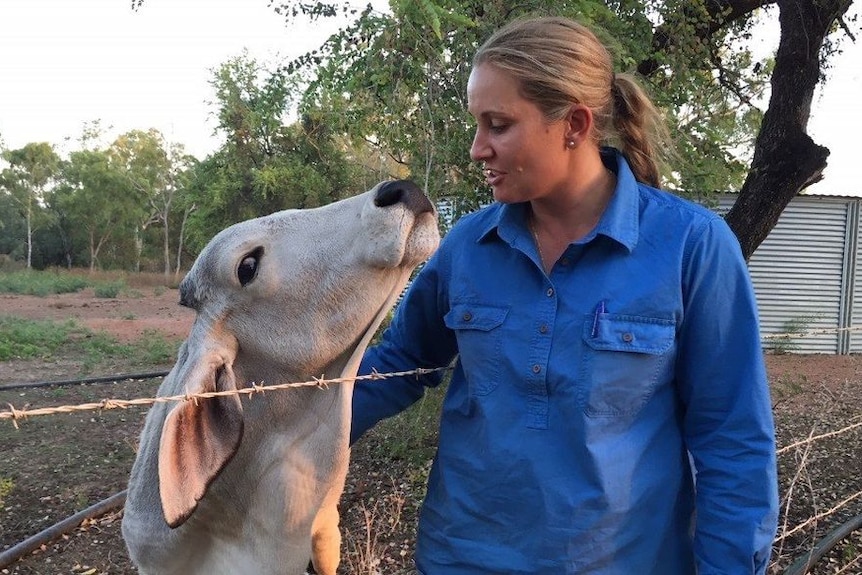 Megan Munchenberg embraces a poddy calf.