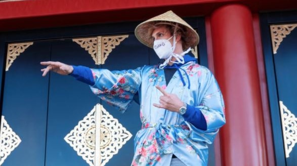 Logan Paul poses in a kimono-style robe in Japan.