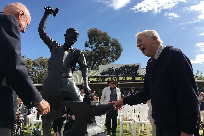 John Taylor, the last surviving son of Headlie Taylor, stands next to his fathers bronze sculpture in Henty NSW