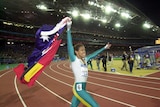 Cathy Freeman holds aloft the Australian and Aboriginal flags after winning Olympic gold in Sydney.