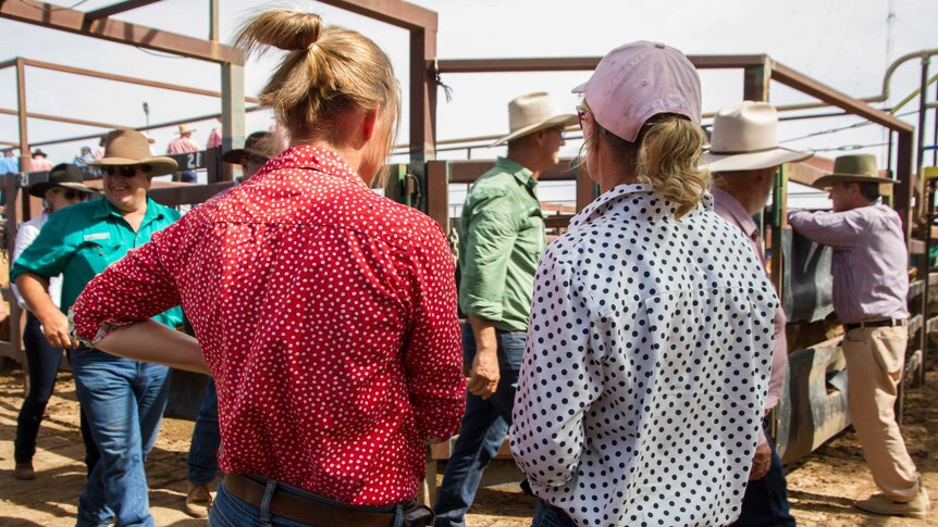 Two women standing in the saleyards to socialise