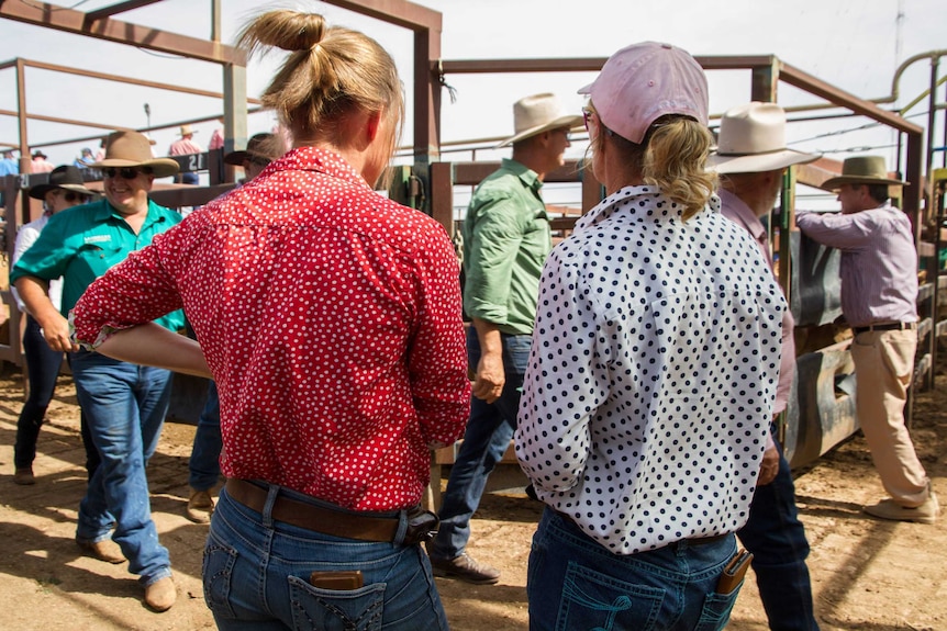 Two women standing in the saleyards to socialise