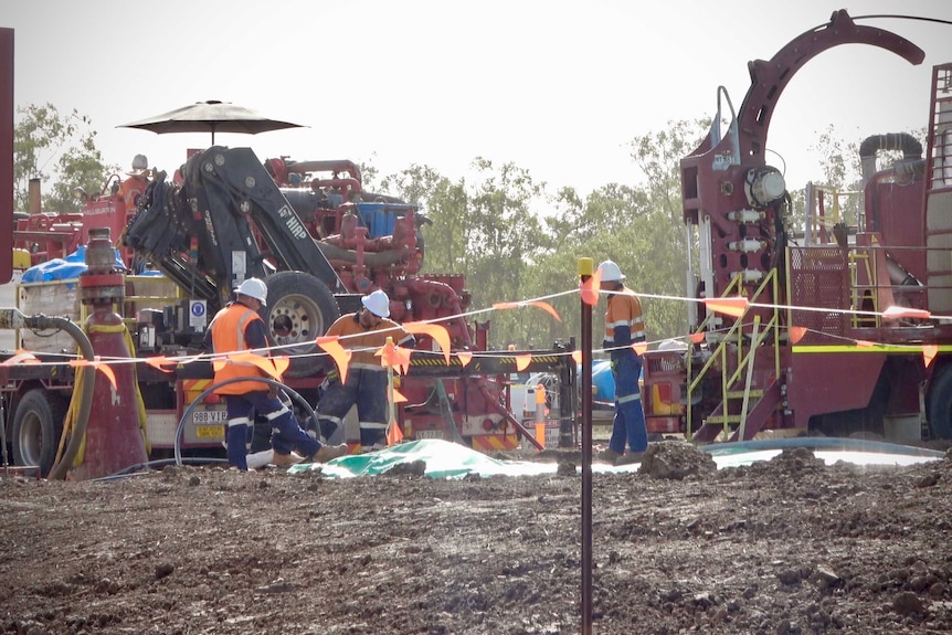 People in high vis vests work to seal a leaking coal exploration well near Chinchilla, August 2020.