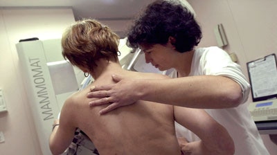 A woman undergoing a mammogram.