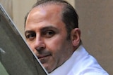Underworld figure Tony Mokbel is lead into a prison van at the Melbourne Supreme Court on October 18, 2011.