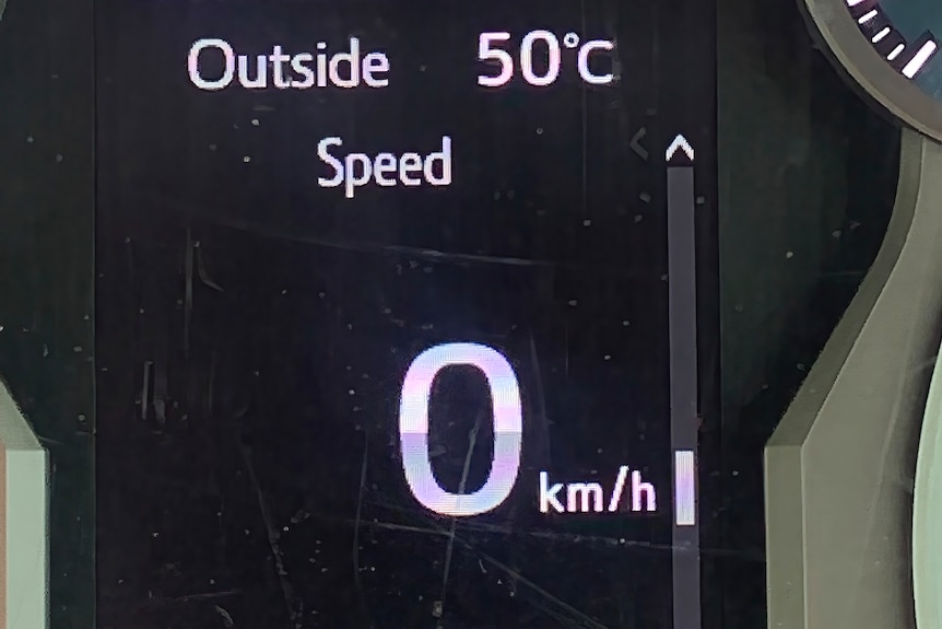 A picture of the car dashboard reading 50 degrees Celsius.