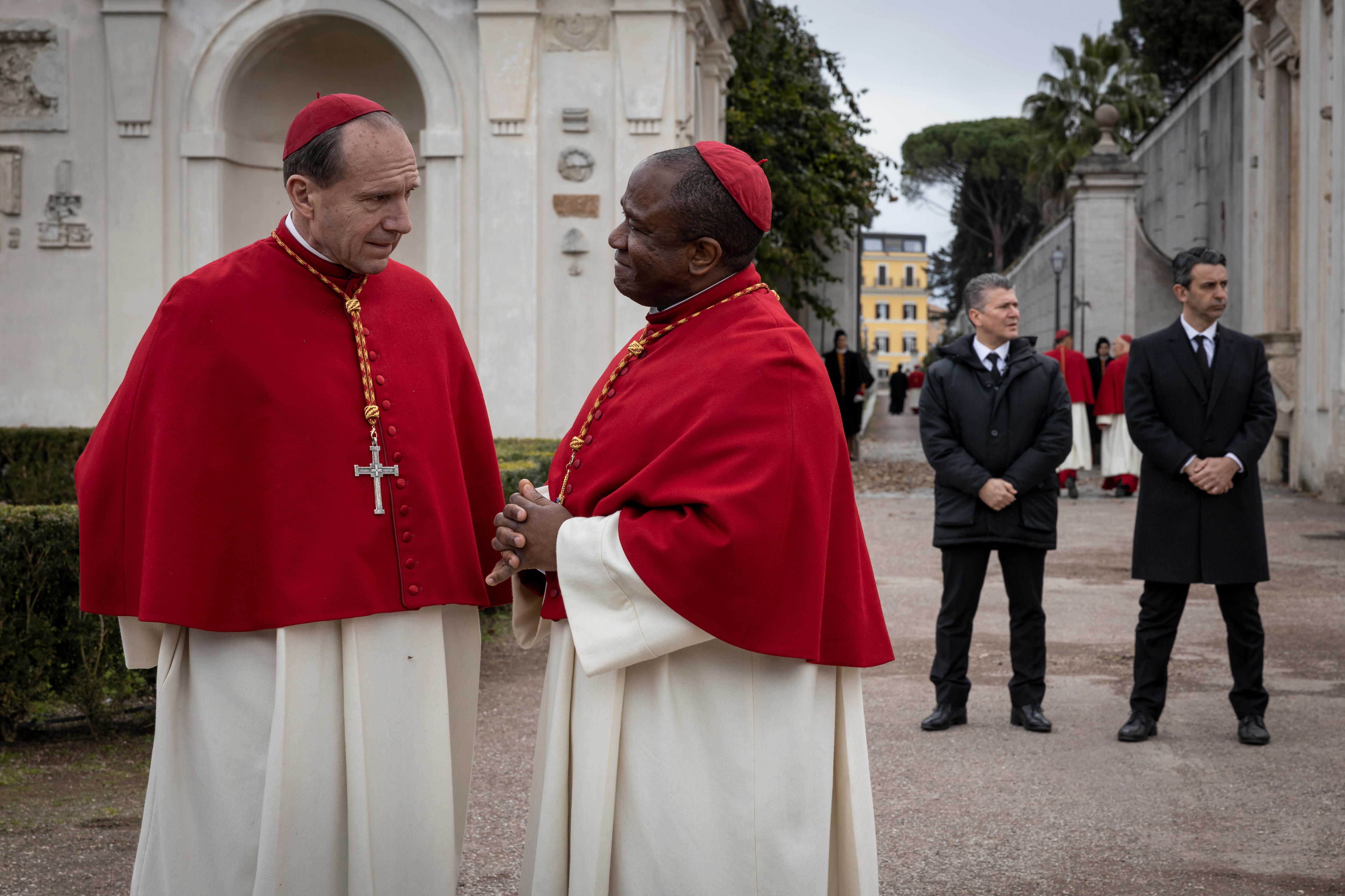 Ralph Fiennes talkes to a fellow cardinal in the film Conclave.