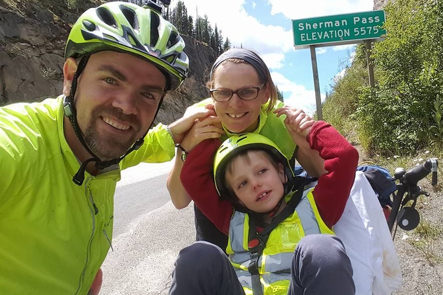 Travis, Fiona and Patch at Sherman Pass on the cycling trip across the US.