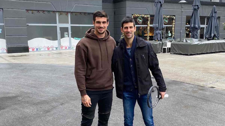 Novak Djokovic stands on the right next to Peta Djordjic in the middle of Belgrade 