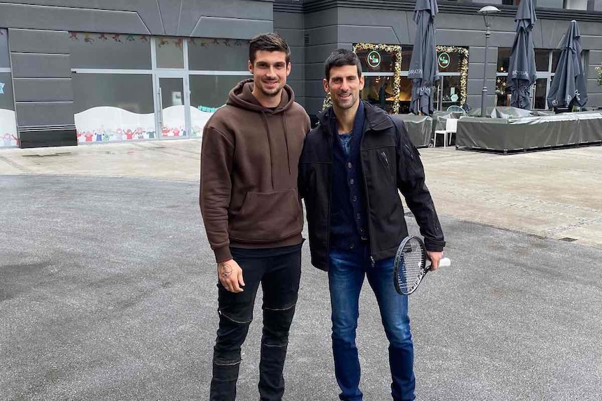 Novak Djokovic stands on the right next to Peta Djordjic in the middle of Belgrade 