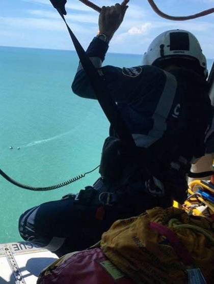 A registrar prepares to jump out of a helicopter on a rescue mission.