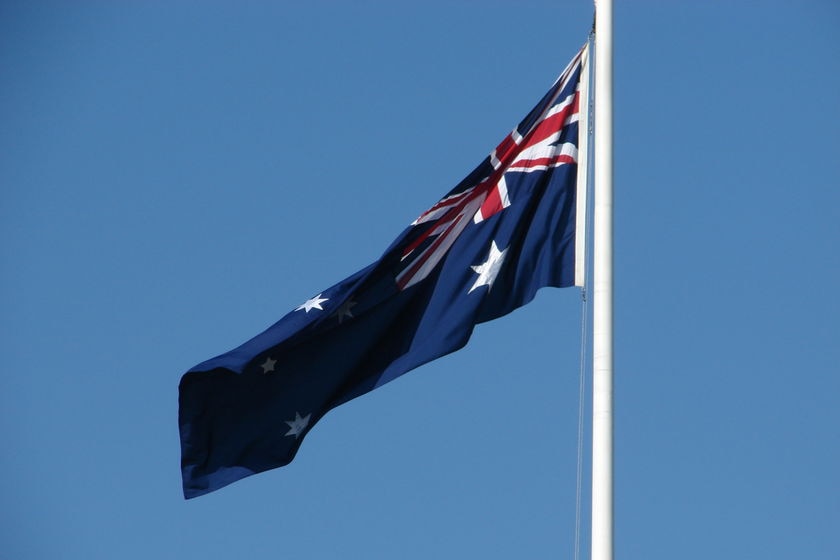 The Australian flag flutters in the wind.