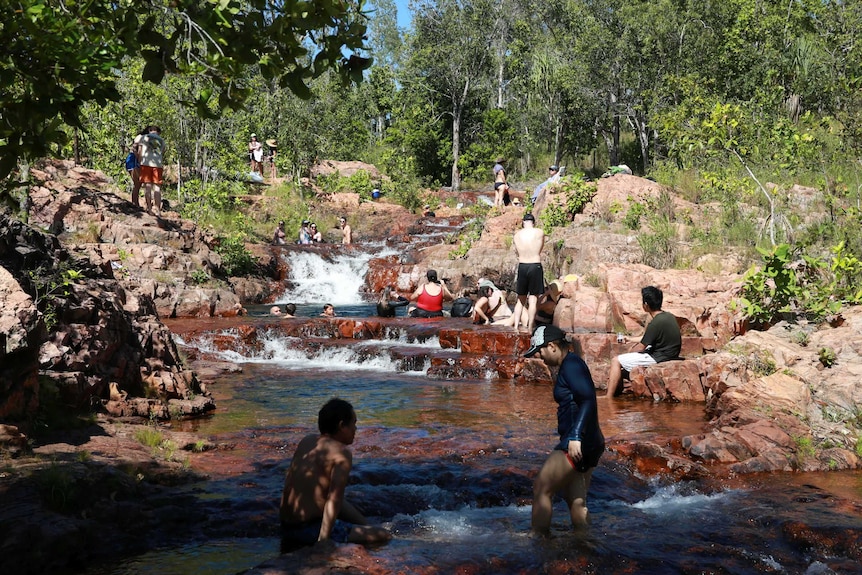 People at Buley Rockhole swim in small pools of water.