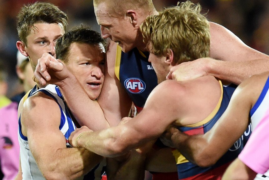 Brent Harvey scuffles with Sam Jacobs and Rory Sloane