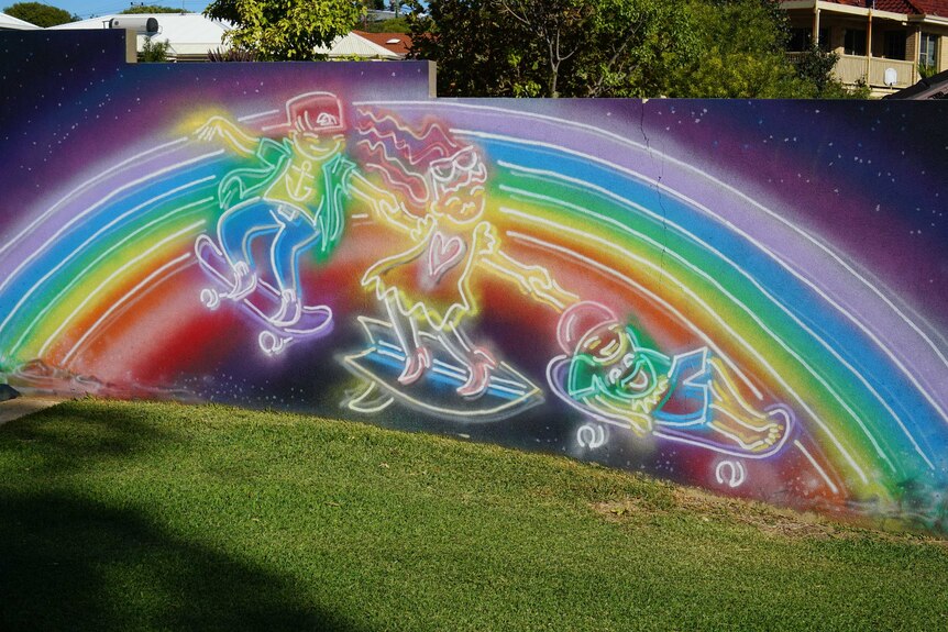 A rainbow painting depicting three children skateboarding