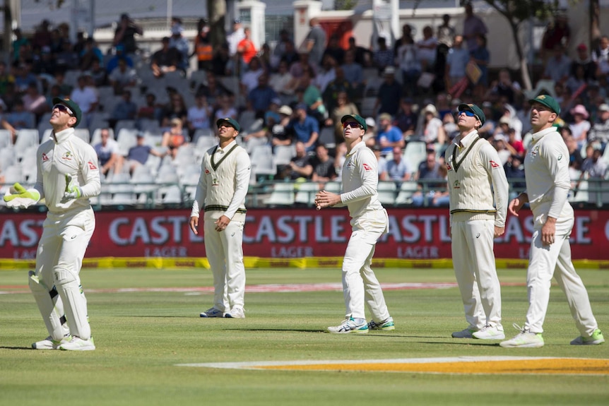 Steve Smith and Australian teammates watch a six fly over their heads