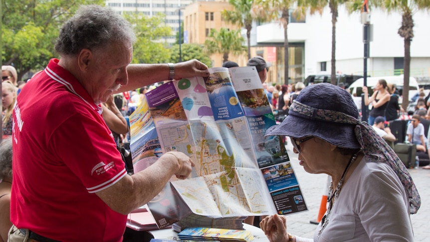 Sydney cruise ambassador Jim Dickie gives a tourist directions