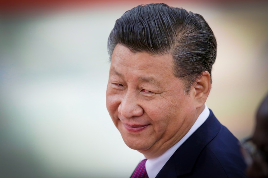 A close-up image of Xi Jinping smiling. 
