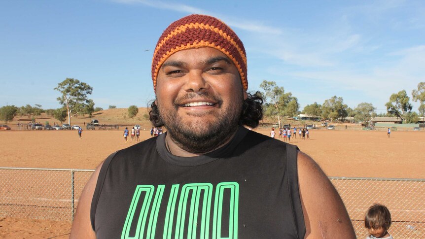 Traditional Owner Damien Williams watching the footy at Hermannsburg Football Oval
