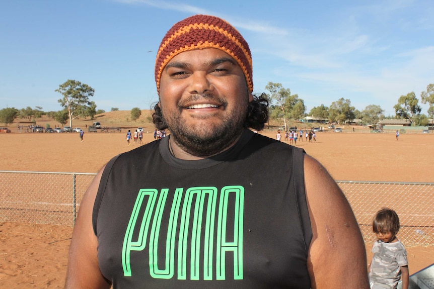 Traditional Owner Damien Williams watching the footy at Hermannsburg Football Oval