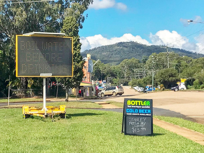 Boil water signs on a large digital display on the side of the road.