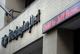 An announcement that The Washington Post has been sold is made outside the Post's office.
