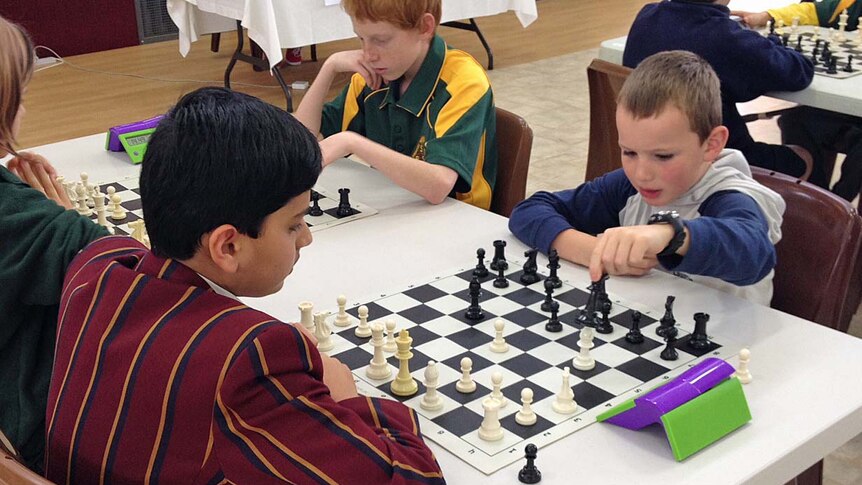 Mind Moves chess club member Liam Rose-Nel (r) competes in a Tasmanian tournament.