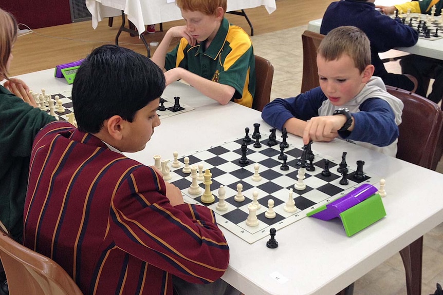 Mind Moves chess club member Liam Rose-Nel (r) competes in a Tasmanian tournament.