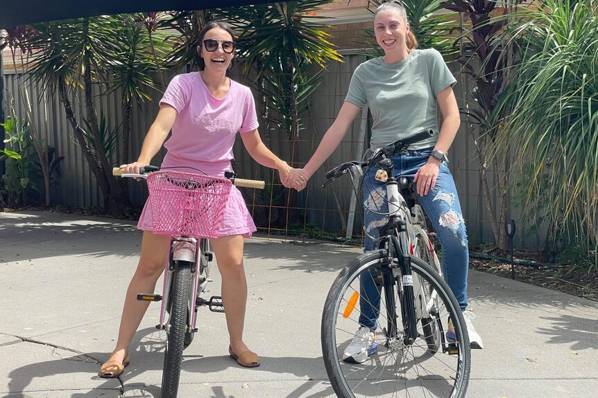 Kelly Wilkinson (right) with her sister riding bikes.