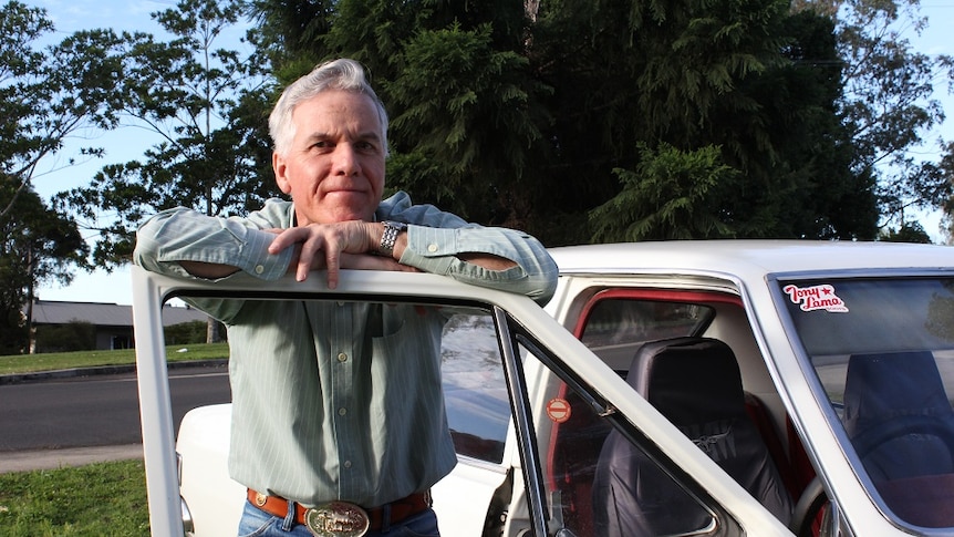 Robbie Gambley leaning on car door