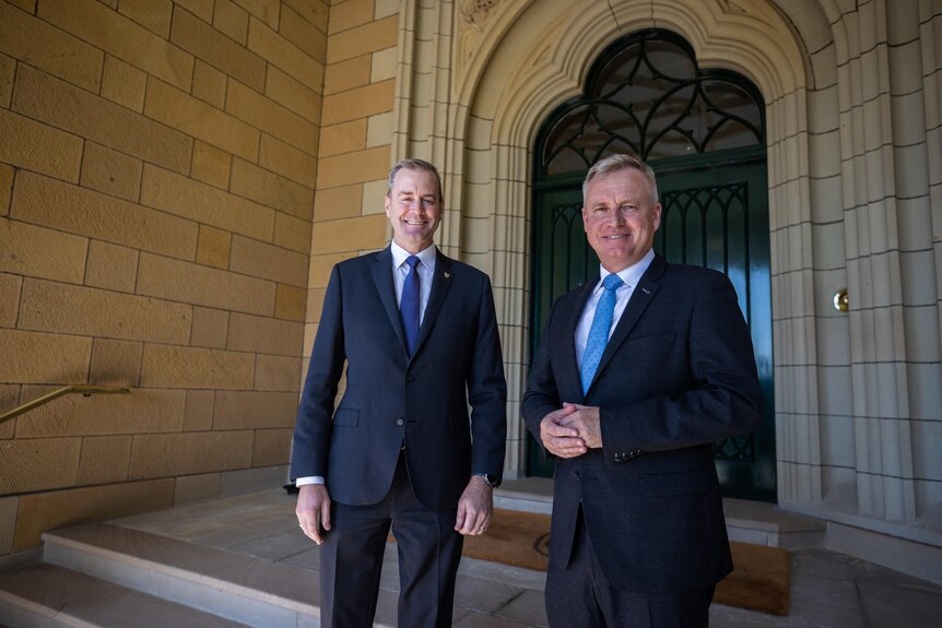Deputy Premier Michael Ferguson and Premier Jeremy Rockliff pose on the steps of government house.