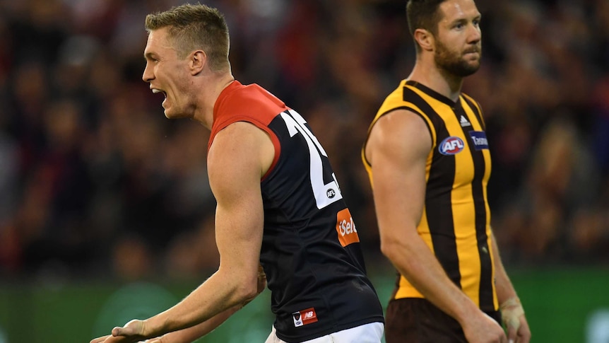 Melbourne's Tom McDonald (L) reacts after kicking a goal against Hawthorn at the MCG.