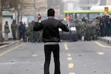 Protester faces down security forces