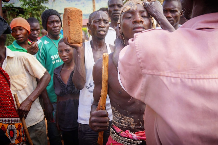 The candidate is covered in millet paste