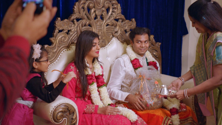 A man and a woman sitting down at an Indian engagement ceremony in a story about Netflix's Indian Matchmaking series.