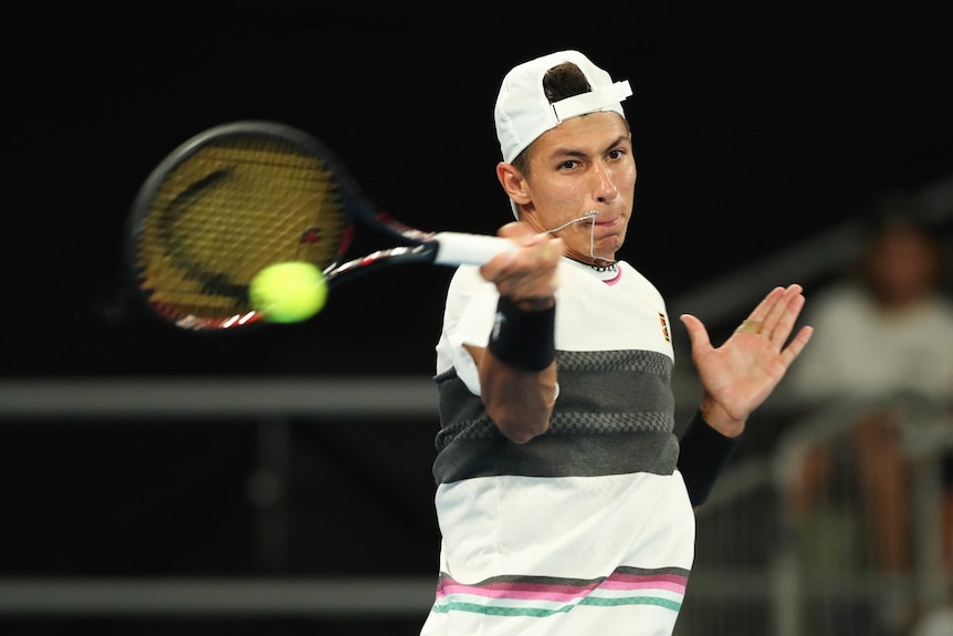 Player swings hard at a forehand at the Australian Open.