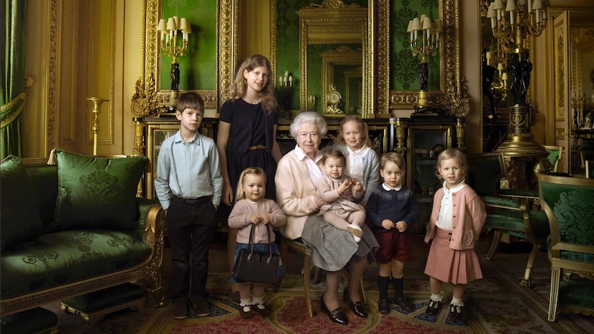 The Queen sits with her five great-grandchildren and two youngest grandchildren in the Green Drawing Room of Windsor Castle.